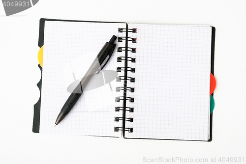 Image of notepad with pen isolated