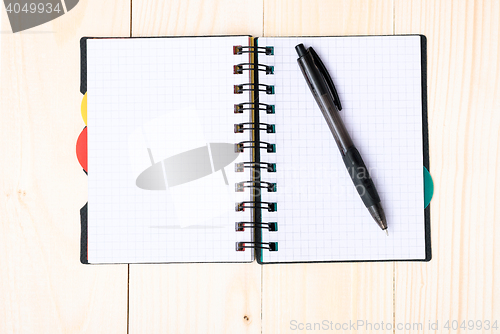 Image of notepad with pen isolated