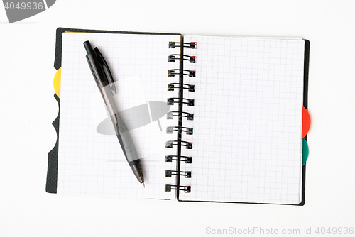 Image of notepad with pen isolated