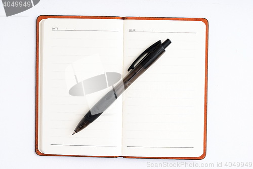 Image of notepad with pen isolated