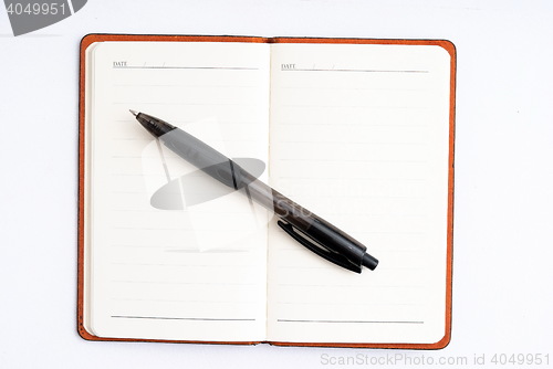 Image of notepad with pen isolated