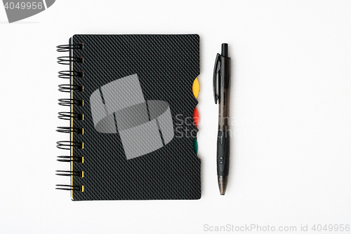 Image of notepad with pen isolated