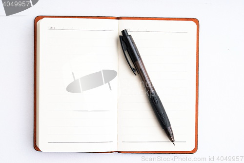 Image of notepad with pen isolated