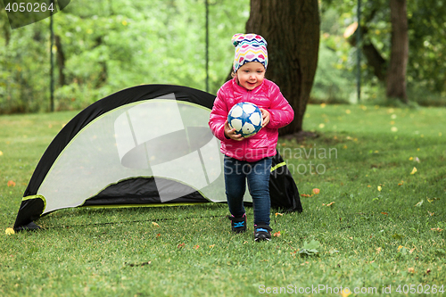 Image of The little baby girl standing at park