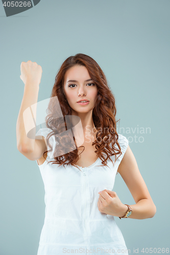 Image of The happy woman on gray background