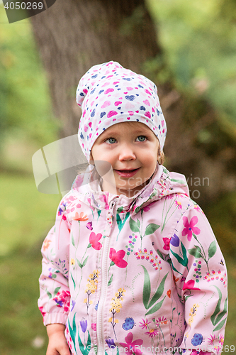 Image of The little baby girl standing at park