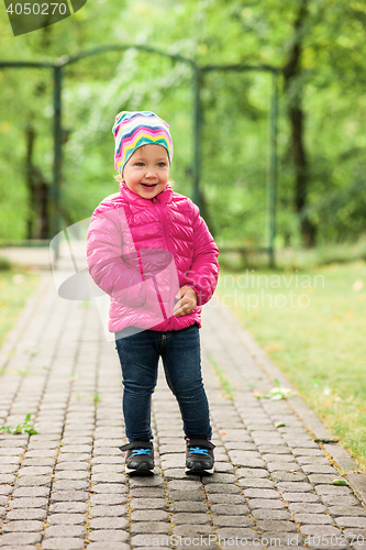 Image of The little baby girl standing at park