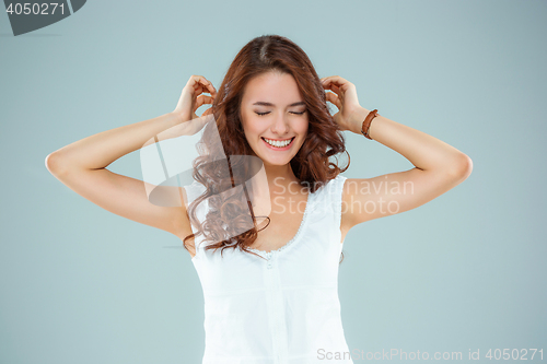 Image of The happy woman on gray background