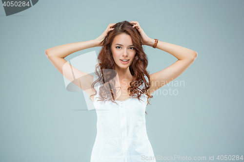 Image of The happy woman on gray background