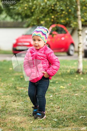 Image of The little baby girl standing at park