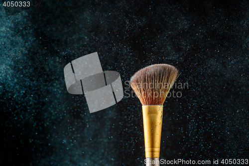 Image of Item makeup - brush on black background with eye shadows