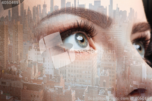 Image of Photo of woman eye and business city. Double exposure