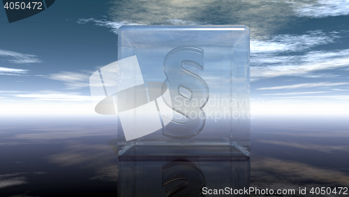 Image of paragraph symbol in glass cube under cloudy sky - 3d rendering