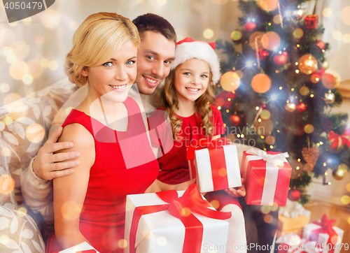 Image of smiling family holding many gift boxes