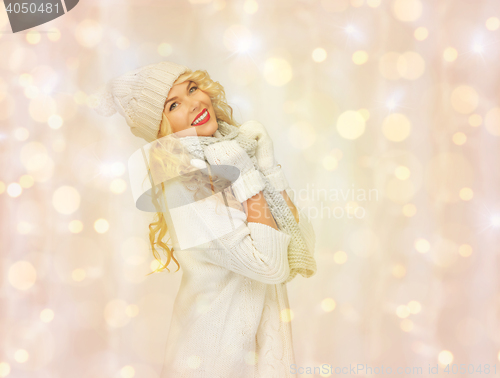 Image of beautiful woman in winter hat, scarf and mittens