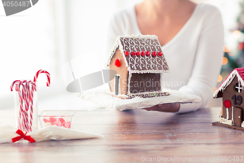 Image of close up of woman showing gingerbread house