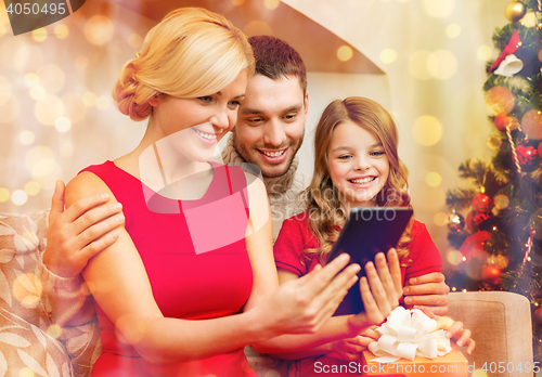 Image of smiling family with tablet pc