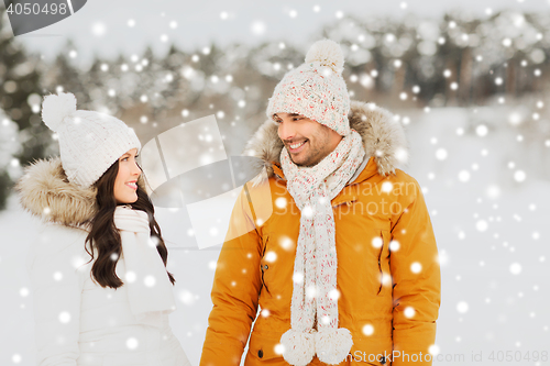 Image of happy couple walking over winter background