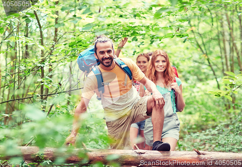 Image of group of smiling friends with backpacks hiking