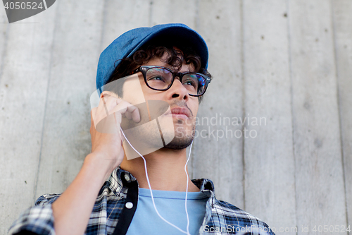 Image of man with earphones listening to music on street