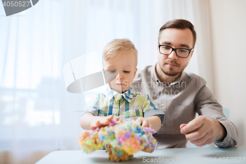 Image of father and son playing with ball clay at home