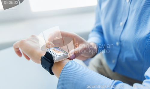 Image of close up of hands with incoming call on smartwatch