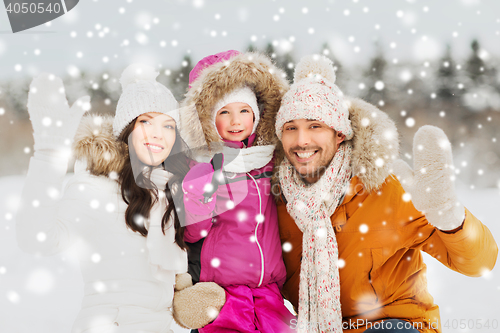 Image of happy family waving hands outdoors in winter