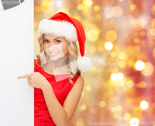 Image of woman in santa helper hat with blank white board