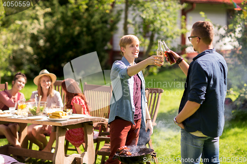 Image of friends drinking beer at summer barbecue party