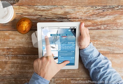 Image of close up of hands with business news on tablet pc