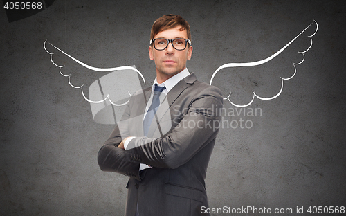 Image of businessman with angel wings over gray