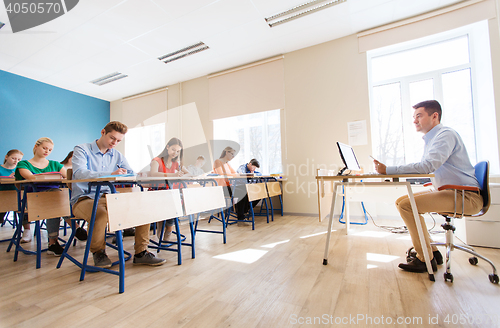 Image of students and teacher with tablet pc at school