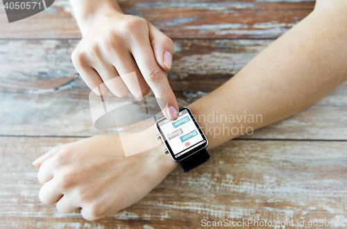 Image of close up of hands with messenger on smart watch