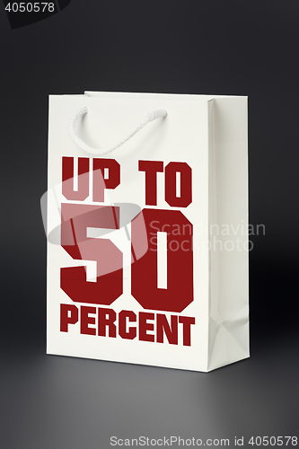 Image of white shopping bag up to 50 percent