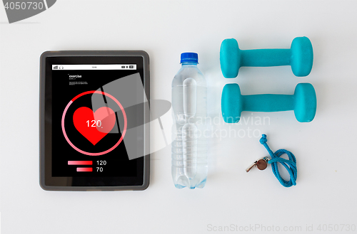 Image of tablet pc, dumbbells, whistle and water bottle