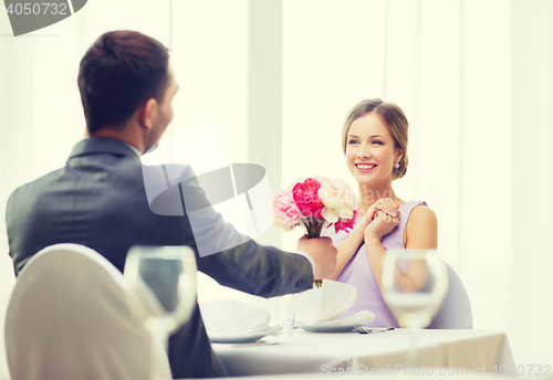 Image of smiling woman recieving bouquet of flowers