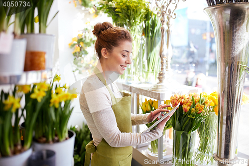 Image of woman with tablet pc computer at flower shop