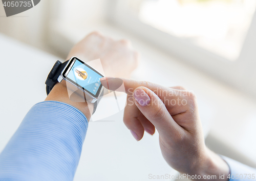Image of close up of hands with music player on smart watch