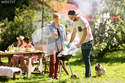 Image of friends making barbecue grill at summer party