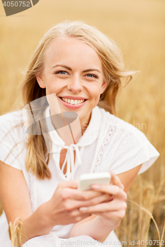 Image of happy woman with smartphone and earphones