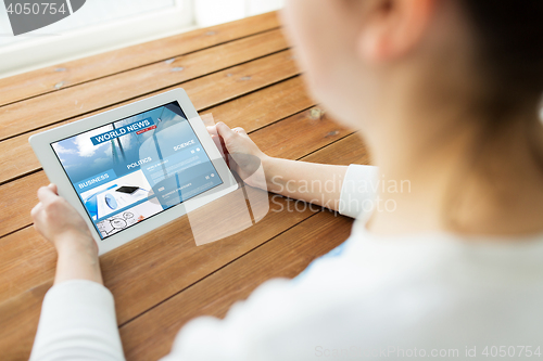 Image of close up of woman with world news on tablet pc