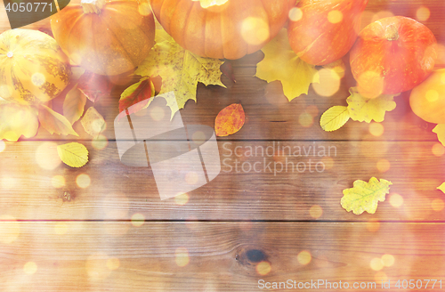 Image of close up of pumpkins on wooden table at home