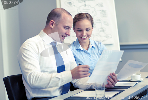 Image of business people with papers meeting in office