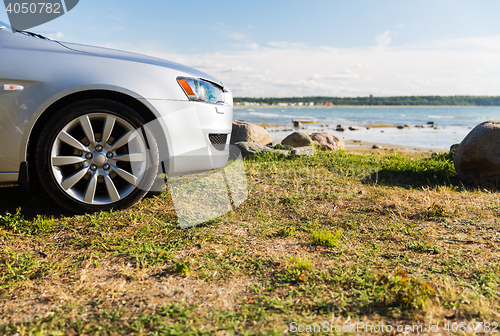 Image of close up of car parked on sea shore or beach