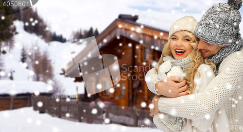 Image of happy family couple in winter clothes hugging