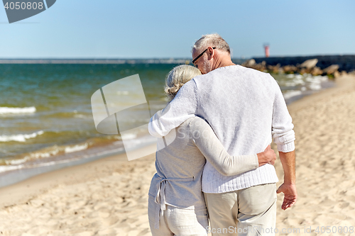 Image of close up of happy senior couple hugging on beach