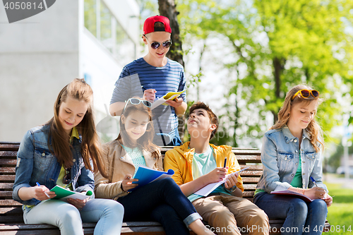 Image of group of students with notebooks at school yard