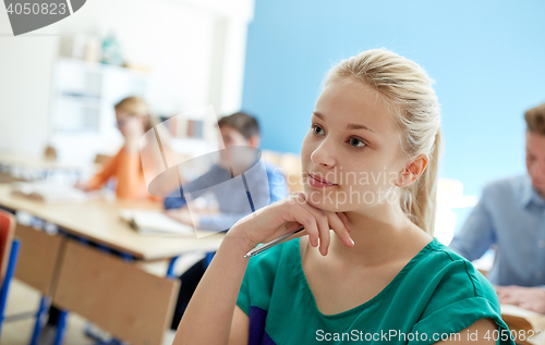 Image of happy student girl at school lesson