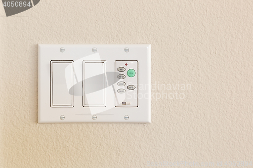 Image of Light Switches and Fan Control on Wall