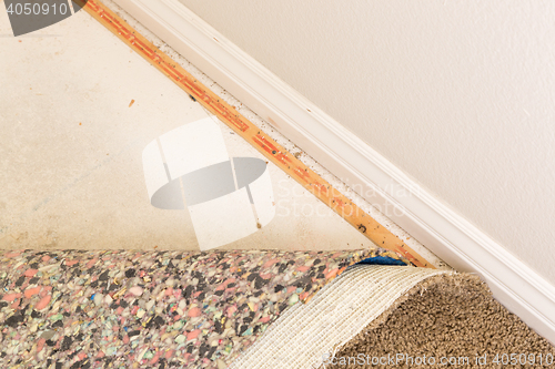 Image of Pulled Back Carpet and Padding In Room